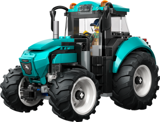 Turquoise LEGO tractor with large tires and mini-figure driver, perfect for imaginative play.